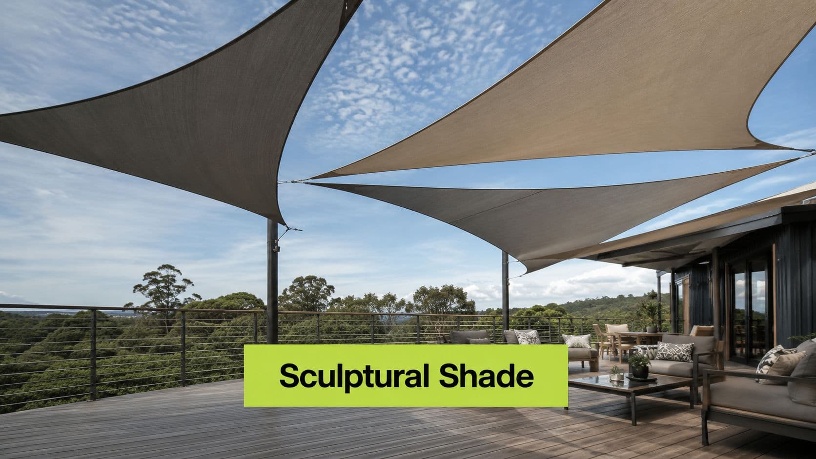 A modern outdoor deck features large triangular fabric shade sails providing stylish protection over comfortable patio furniture.