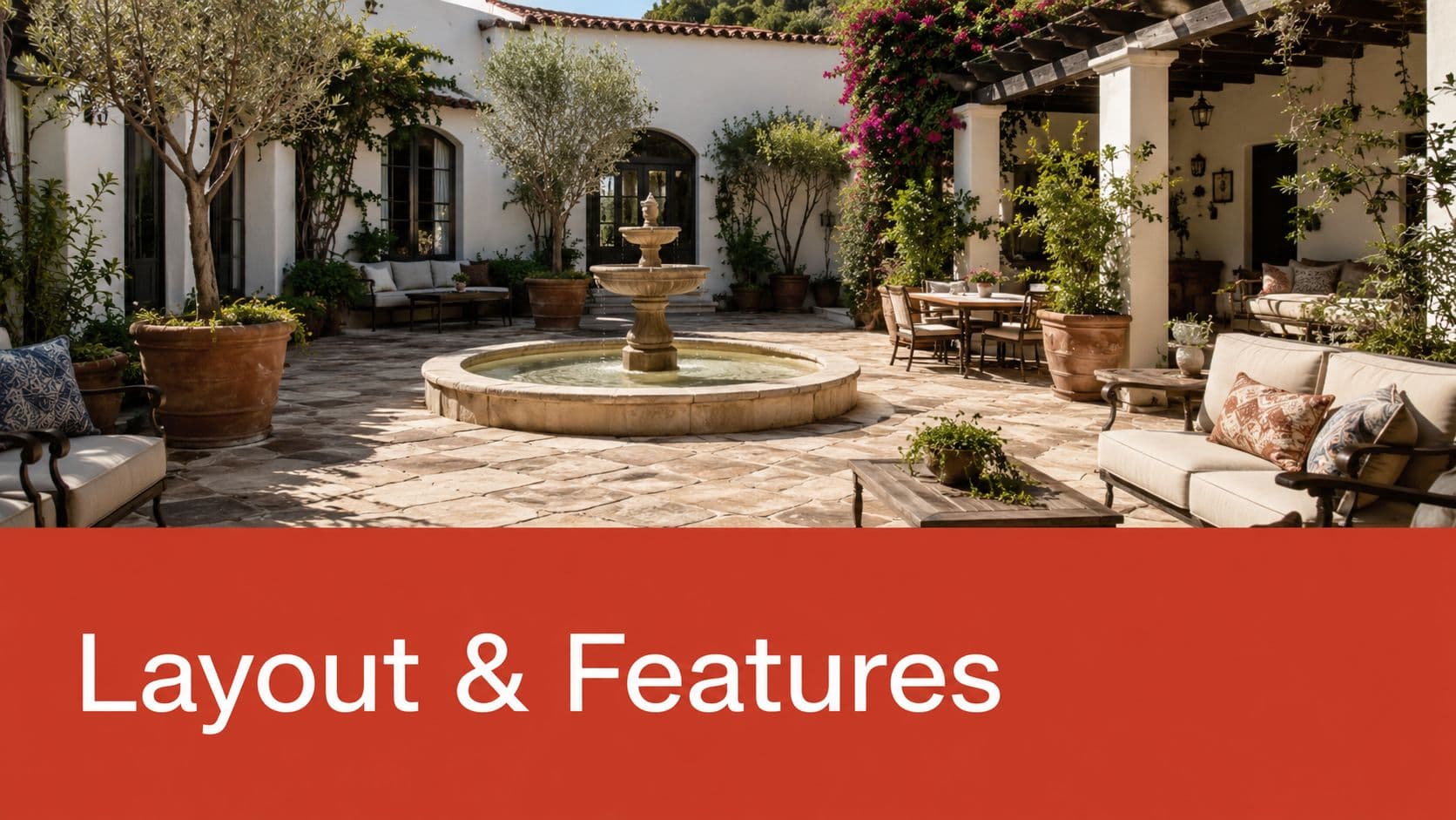 A luxurious Mediterranean style patio with a central stone fountain, lush greenery, and comfortable outdoor furniture seating.